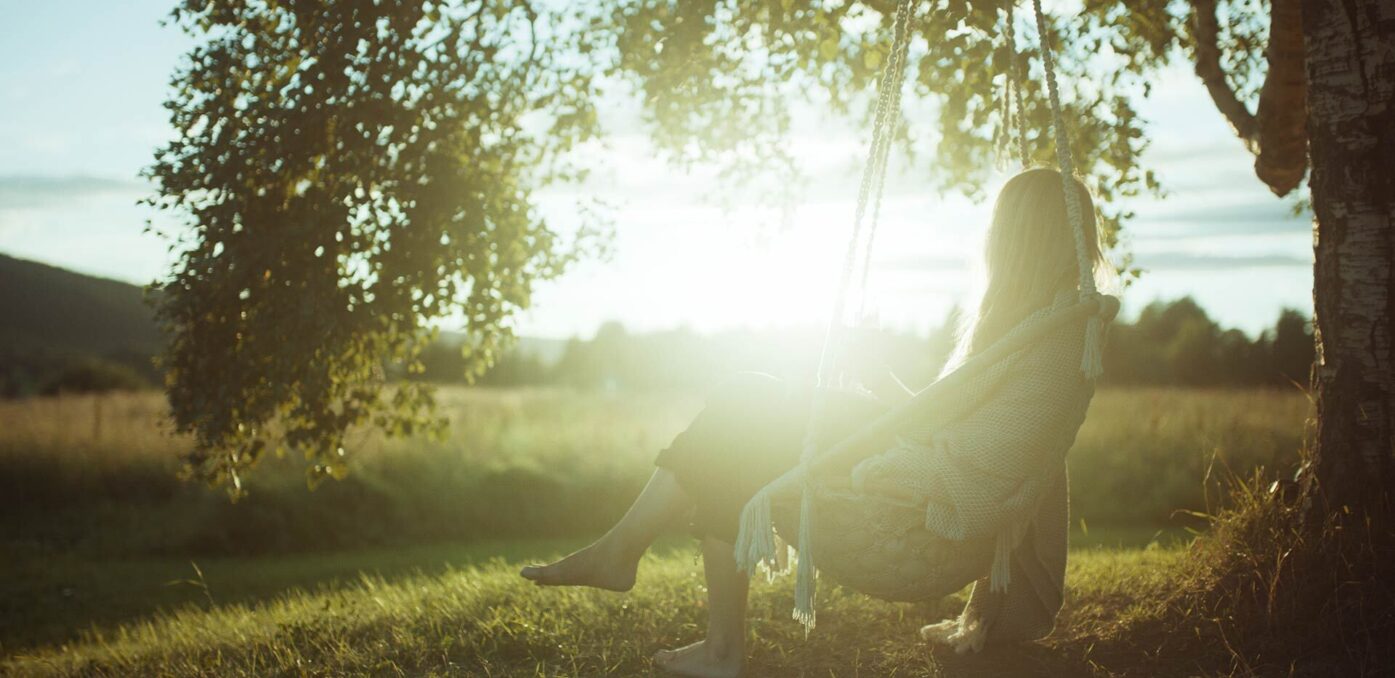 Woman sitting in a chair, looking at the sunset