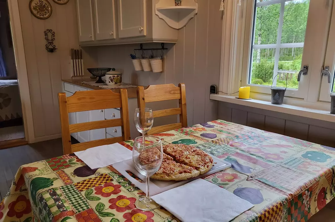 Kitchen table with a pizza